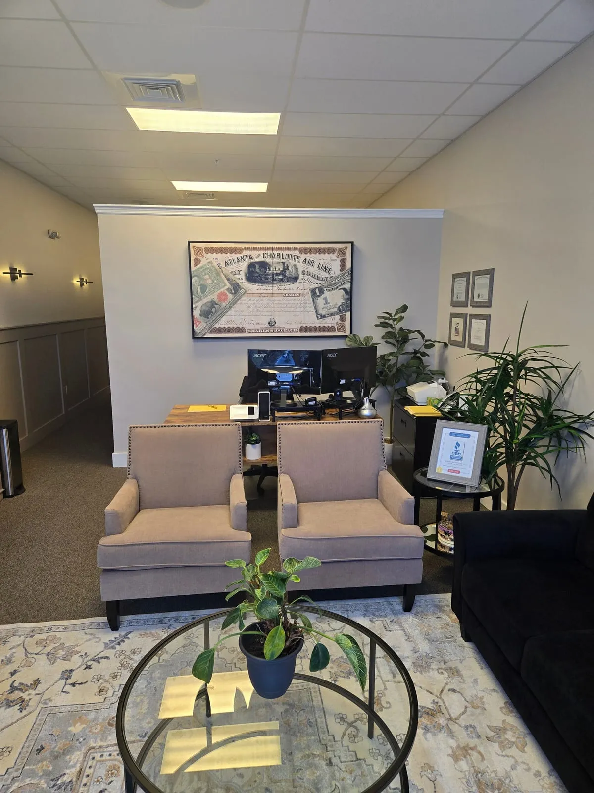 Two beige chairs facing the front desk in the Golinski Tax Prep lobby, Spring Hill